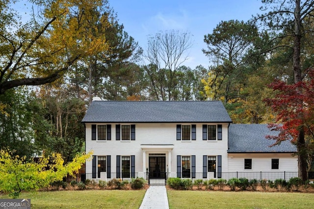 colonial home with a front lawn