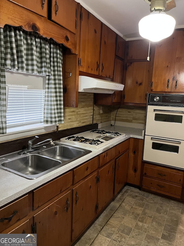 kitchen featuring white appliances and sink