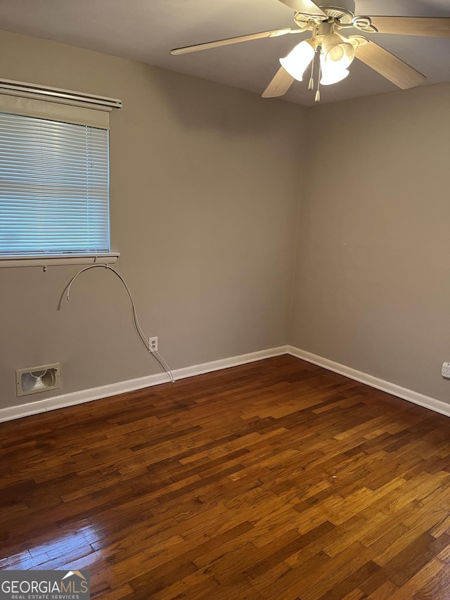 unfurnished room with ceiling fan and dark wood-type flooring