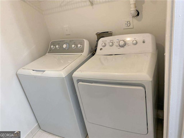 clothes washing area featuring washer and dryer