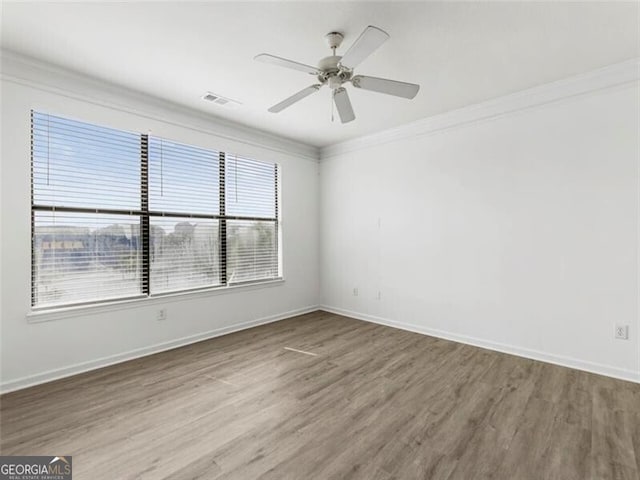 unfurnished room featuring ceiling fan, crown molding, and wood-type flooring