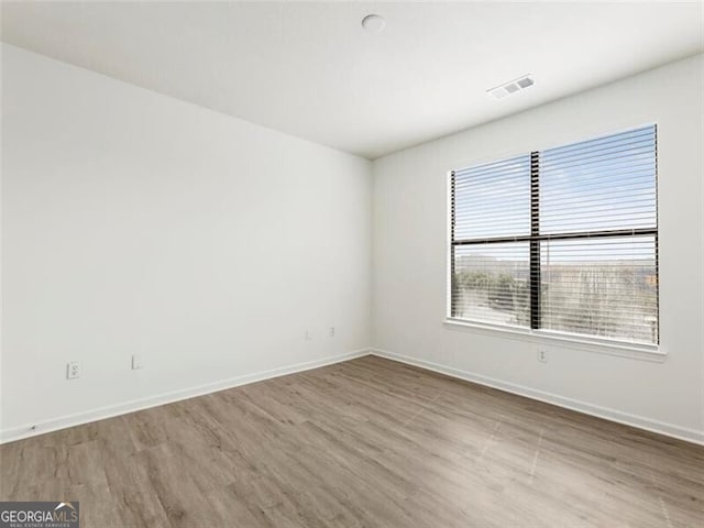 unfurnished room with light hardwood / wood-style flooring