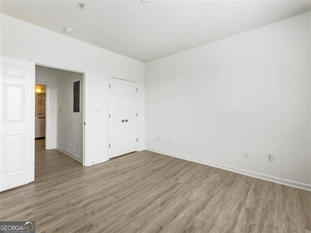 unfurnished bedroom with hardwood / wood-style floors and a closet