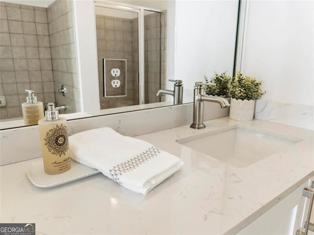 bathroom featuring vanity and a shower with shower door