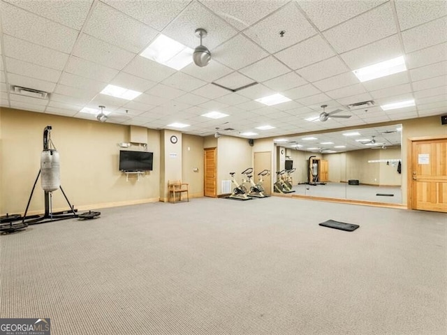 exercise area with a paneled ceiling and carpet floors