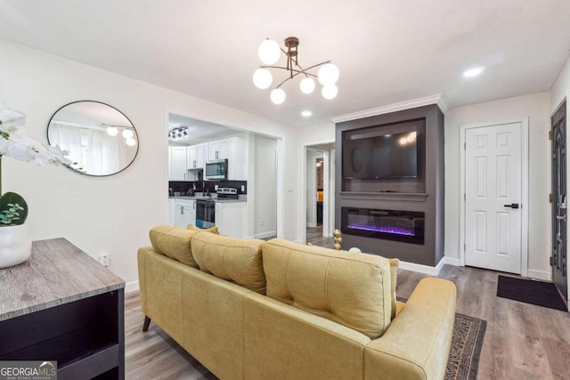 living room with wood-type flooring and an inviting chandelier