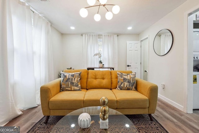 living room featuring hardwood / wood-style flooring and an inviting chandelier