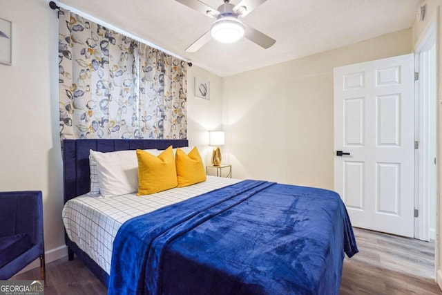 bedroom featuring ceiling fan and wood-type flooring