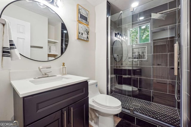 bathroom featuring vanity, toilet, and a shower with door