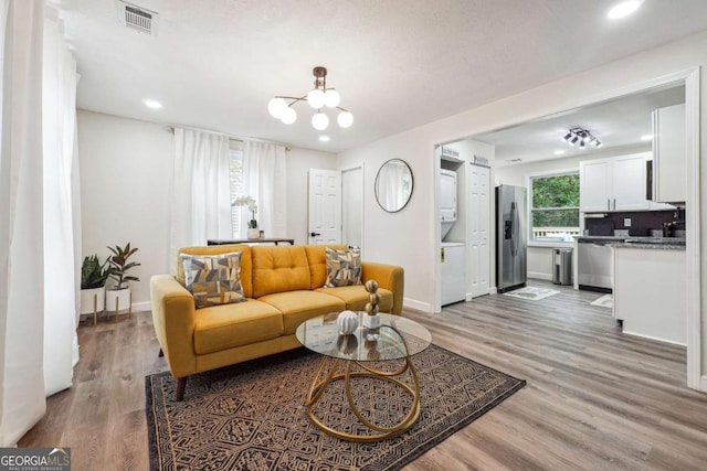 living room with a chandelier and light hardwood / wood-style flooring