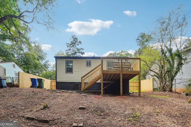 rear view of property with a wooden deck