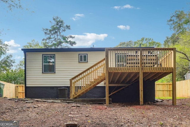 rear view of property with a wooden deck