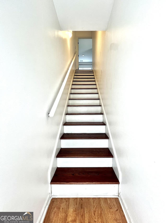 staircase featuring hardwood / wood-style floors