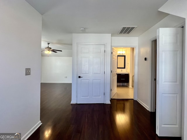 corridor featuring dark hardwood / wood-style flooring