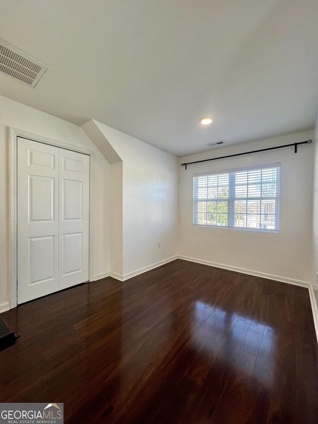 additional living space with dark hardwood / wood-style floors