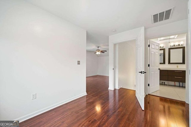 unfurnished room featuring ceiling fan and dark hardwood / wood-style flooring