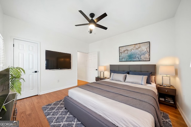 bedroom with ceiling fan and hardwood / wood-style floors