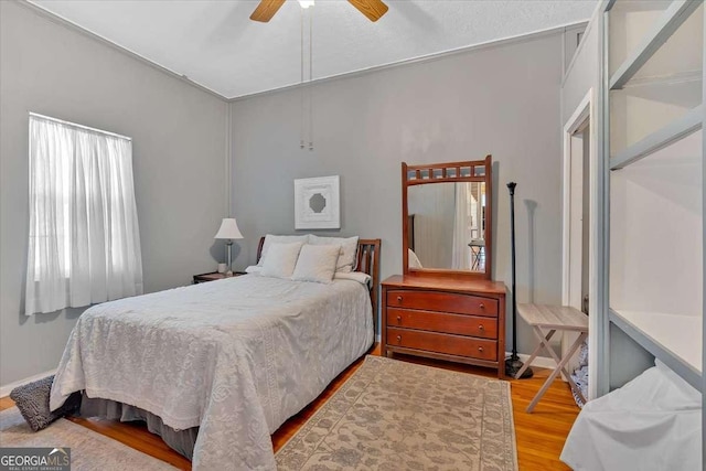 bedroom with ceiling fan and wood finished floors