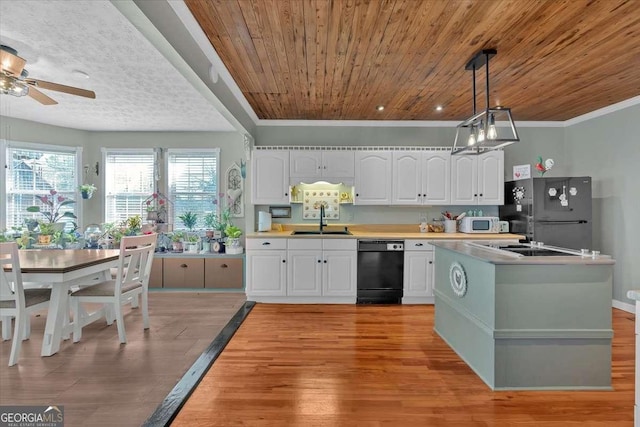 kitchen with black appliances, white cabinetry, and a sink