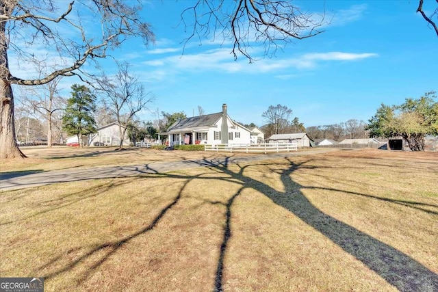 view of front of home featuring fence and a front yard