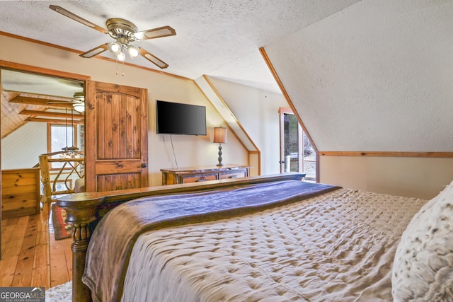 bedroom with a textured ceiling, ceiling fan, and wood walls