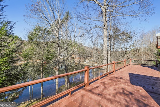 wooden terrace featuring a water view