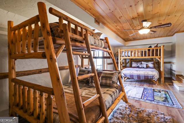 bedroom featuring ceiling fan, hardwood / wood-style floors, and wooden ceiling