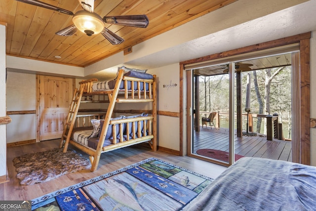 bedroom featuring hardwood / wood-style floors, access to outside, ceiling fan, and wood ceiling