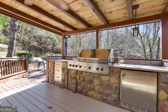 wooden terrace with area for grilling and a grill