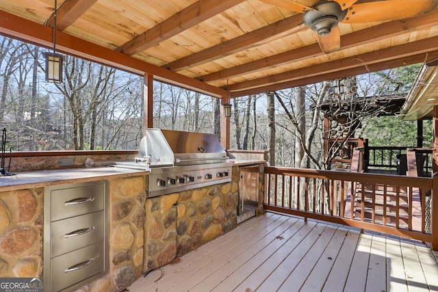 deck with ceiling fan, area for grilling, and grilling area