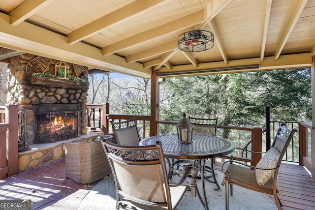 deck featuring an outdoor stone fireplace