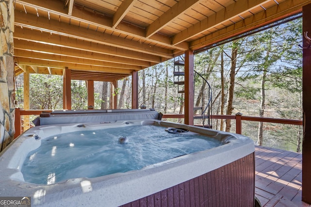 wooden deck with a hot tub