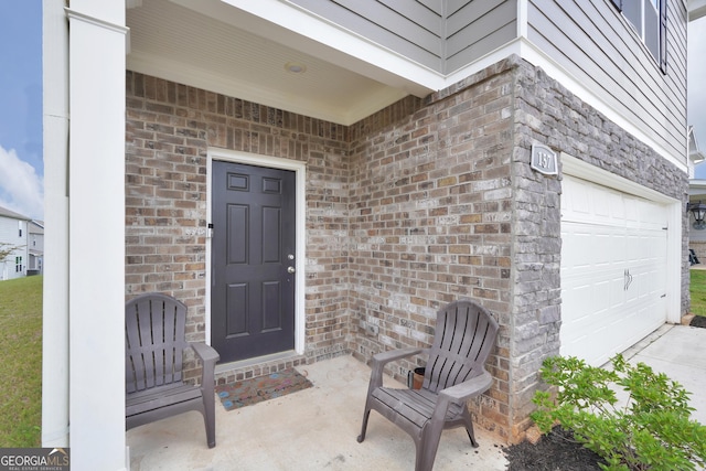 view of exterior entry with a garage