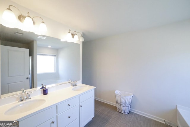 bathroom with vanity and a bath