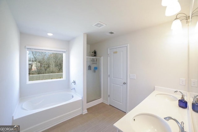 bathroom featuring vanity and shower with separate bathtub