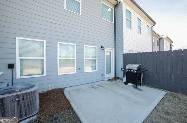 exterior space featuring central AC unit and a grill