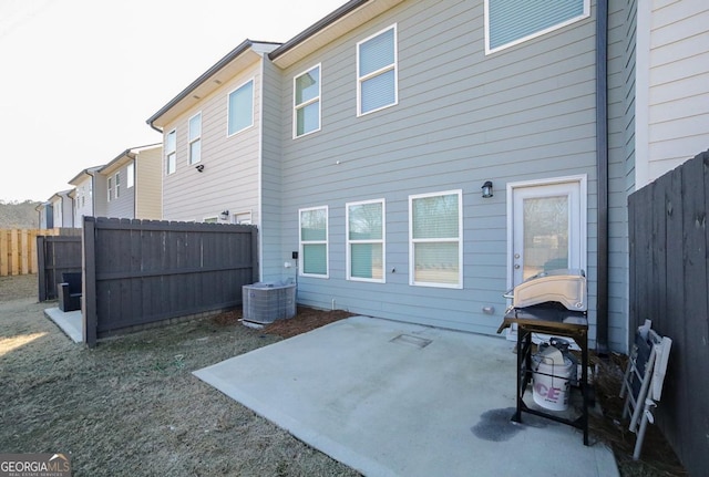 rear view of property featuring cooling unit and a patio area