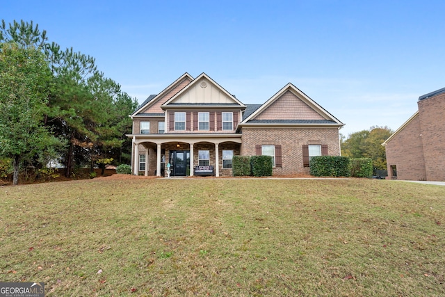 craftsman inspired home featuring a porch and a front yard