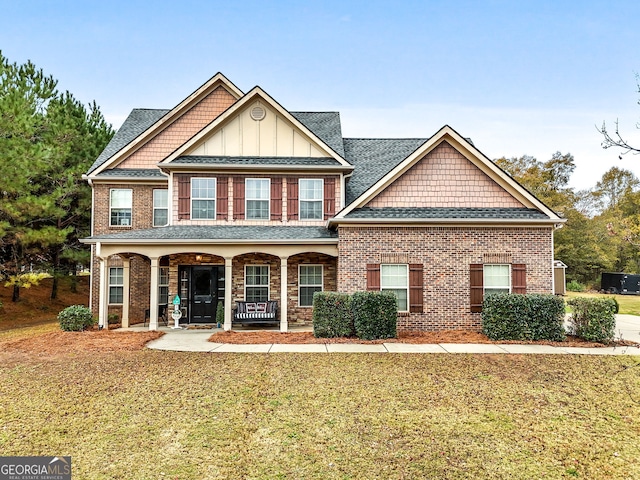 craftsman-style home featuring a porch and a front lawn