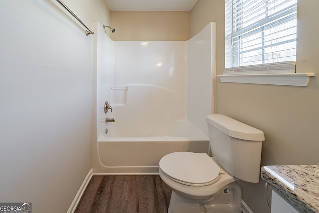 bathroom with hardwood / wood-style floors, toilet, and shower / tub combination