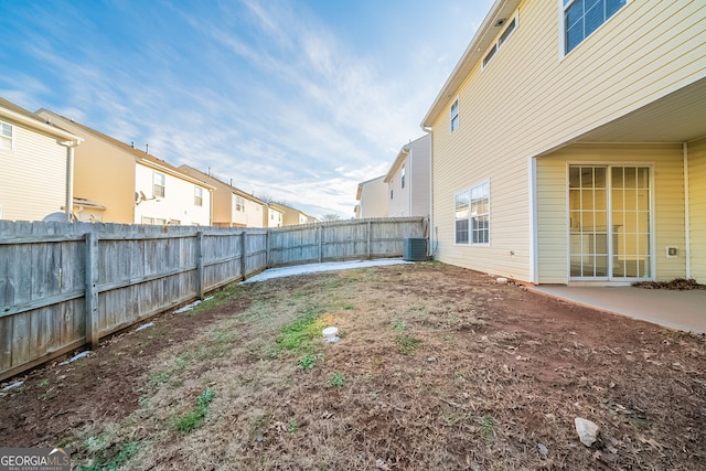 view of yard featuring central AC unit and a patio area