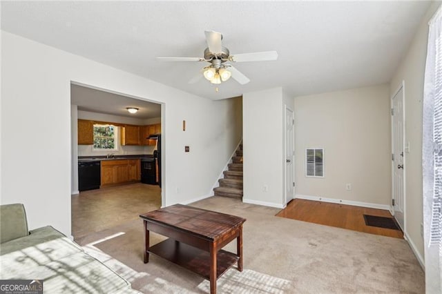 carpeted living room featuring ceiling fan