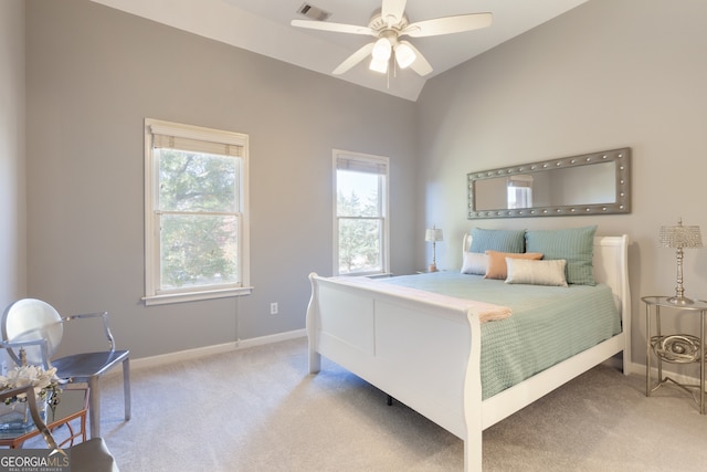 bedroom featuring ceiling fan, light colored carpet, and lofted ceiling