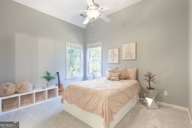 carpeted bedroom featuring high vaulted ceiling and ceiling fan