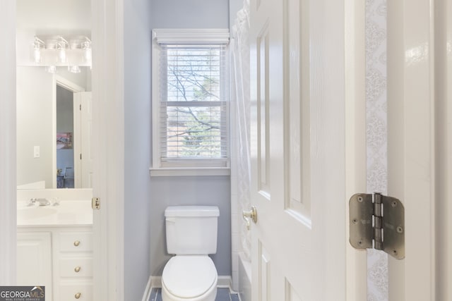 bathroom featuring vanity, toilet, and a wealth of natural light