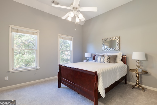 carpeted bedroom with ceiling fan and vaulted ceiling