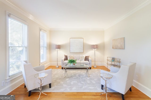 sitting room featuring crown molding, plenty of natural light, and hardwood / wood-style floors