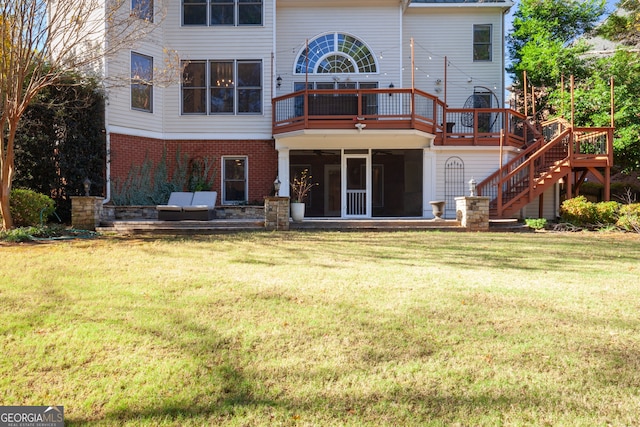 back of house featuring a yard, a deck, and a sunroom