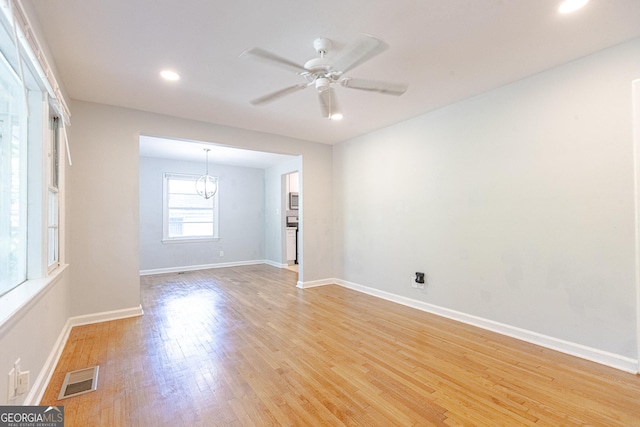 empty room featuring light wood-type flooring and ceiling fan