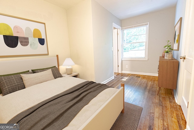 bedroom with hardwood / wood-style floors